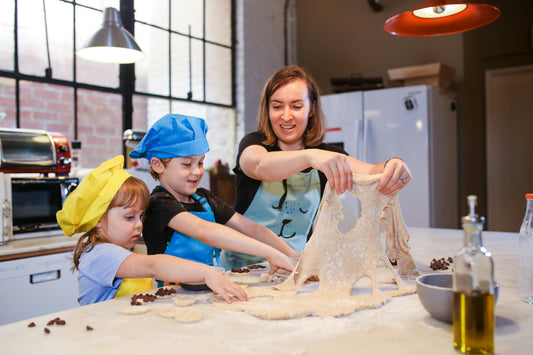 Mother and children baking cookies together using fun fall cookie cutters, a family-friendly seasonal activity perfect for kids and classrooms.