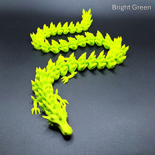 Bright green flexible dragon toy with movable segments, handmade from biodegradable PLA, ideal for sensory play or fantasy fans.