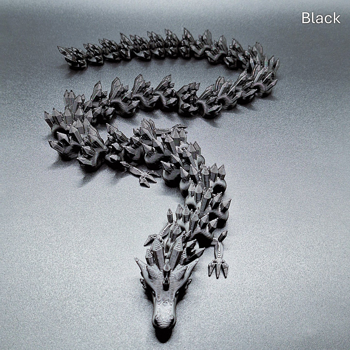 Magenta articulated dragon toy with smooth, movable segments, 3D printed in eco PLA plastic, ideal for stress relief and collectors.