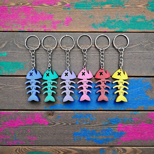 Articulated fish keychains shown in multiple colors, perfect for gag gifts, stocking stuffers and party favors.