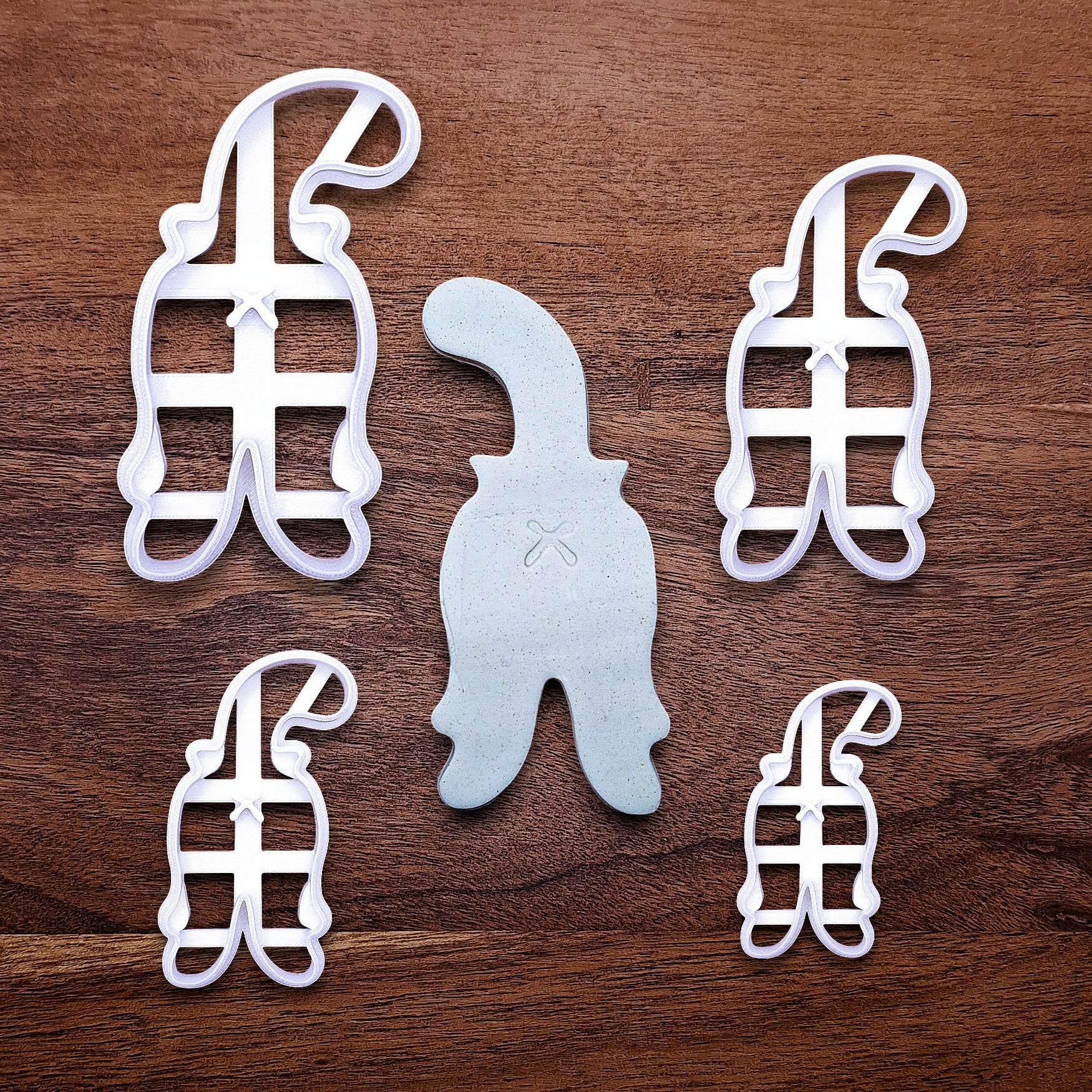 Cat butt cookie cutters with stamps and dough cutout showing crisp, hilarious feline-shaped cookies—ideal for cat lovers and novelty baking gifts.