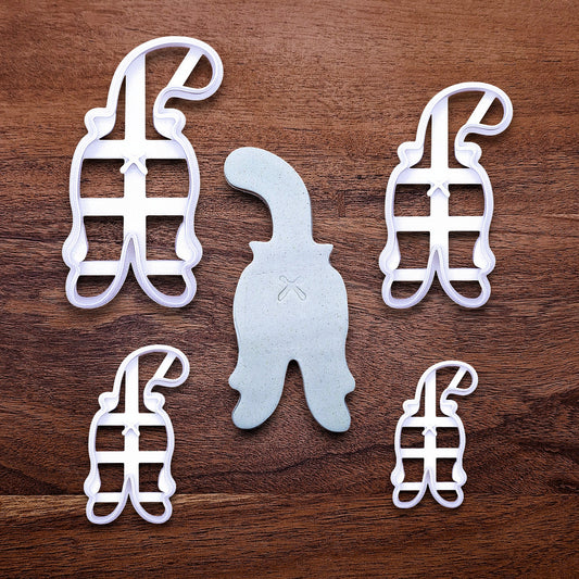 Cat butt cookie cutters with stamps and dough cutout showing crisp, hilarious feline-shaped cookies—ideal for cat lovers and novelty baking gifts.