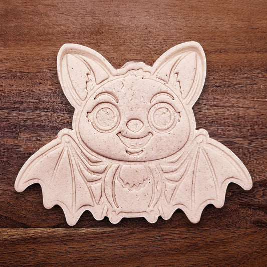 Stamped cute bat cookie dough with cute details from cutter and stamp set—perfect for cute and spooky Halloween bakes without the need for piping.