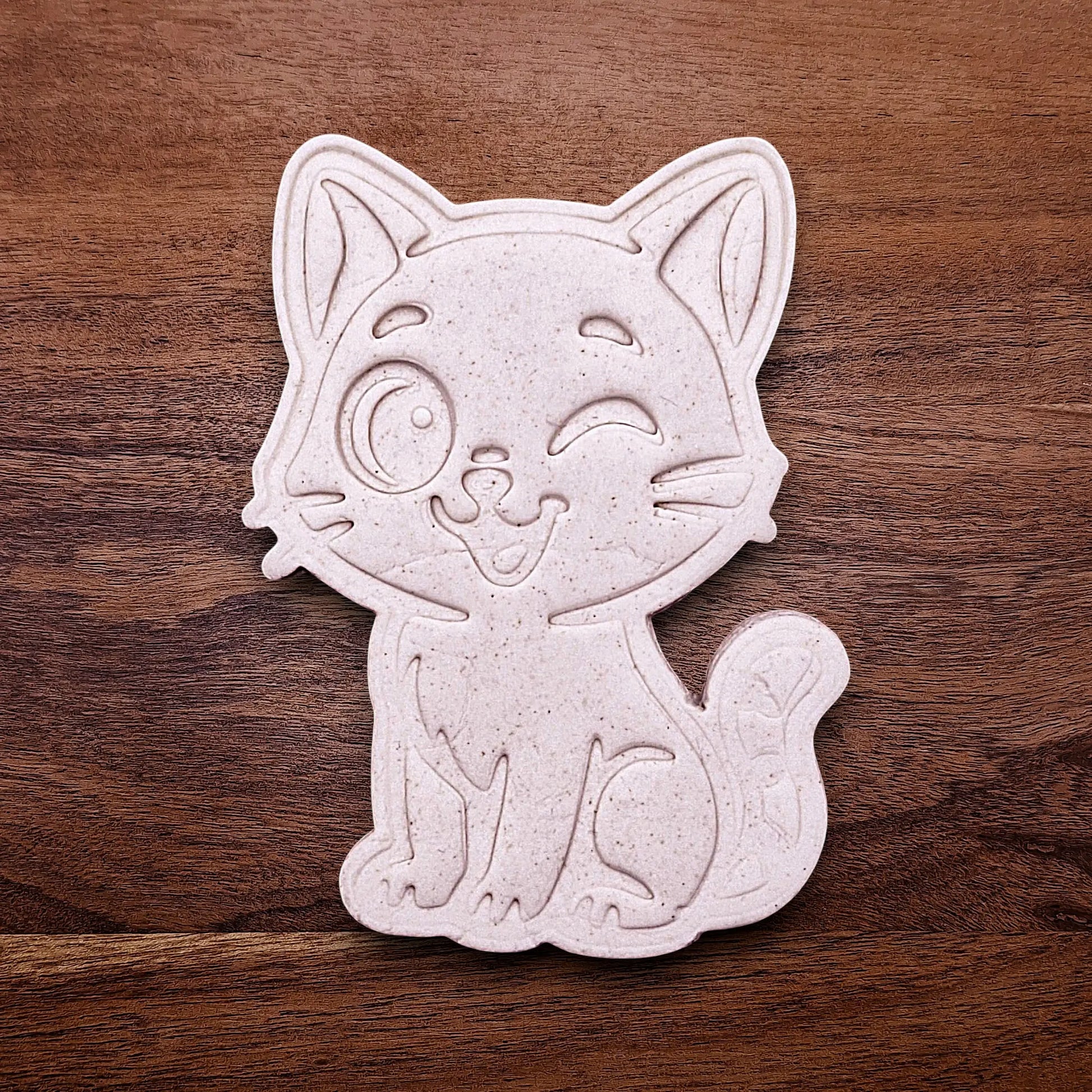 Winking cat customizable cookie cutter dough cutout and imprint, great for creating detailed, cat-themed cookies, fondant pieces, or party treats for birthdays, parties and craft projects.