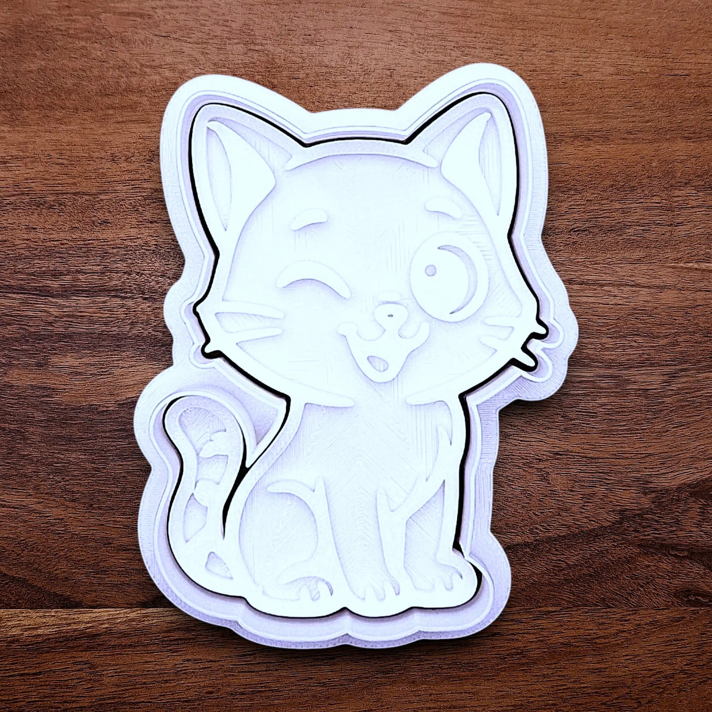 Winking cat cookie cutter and stamp, great for creating detailed, cat-themed cookies, fondant pieces, or party treats for birthdays, parties and craft projects.