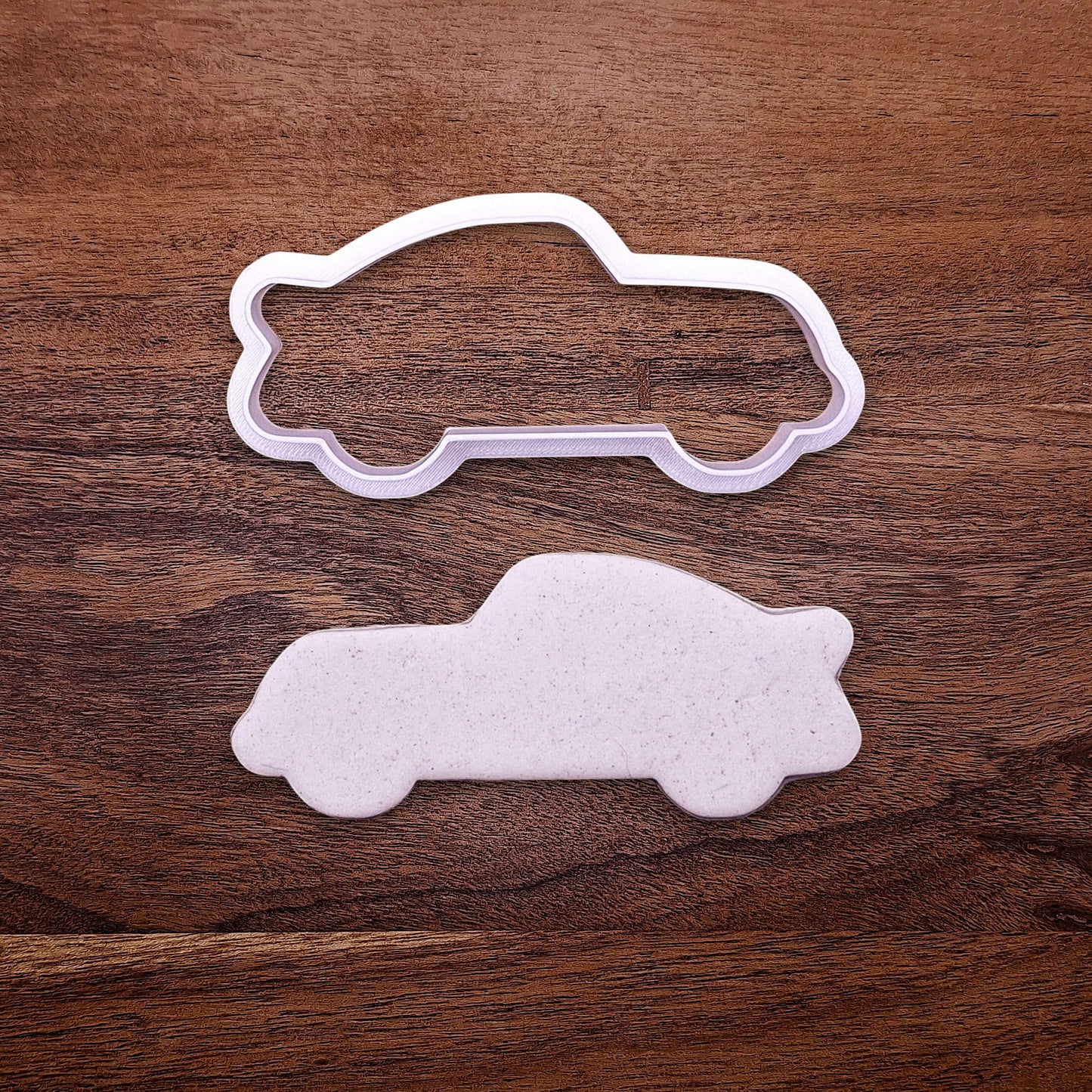 Racecar cookie cutter and dough cutout, perfect for racing-themed birthday treats, car cookies, or fun fondant decorations.