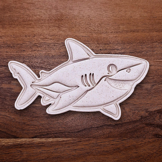 Shark cookie dough cutout with stamped fin and face detail. Perfect for beach parties, ocean birthdays, and kid-friendly shark bakes.