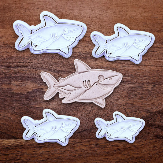 Multiple customizable ocean shark cookie cutters and stamps, creates standout ocean cookies with charming face and fin details, perfect for themed birthdays, baby showers, and beach parties.