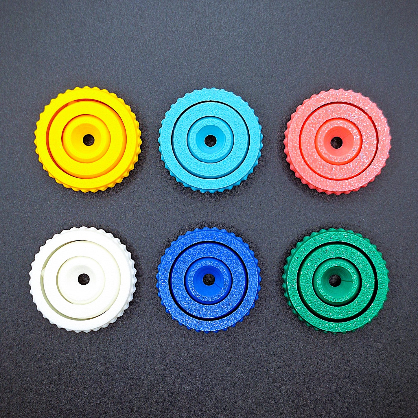 Six fidget gyro spinners with modern designs and smooth spin, handmade from eco PLA, great for stress relief, sensory play, and focus support.