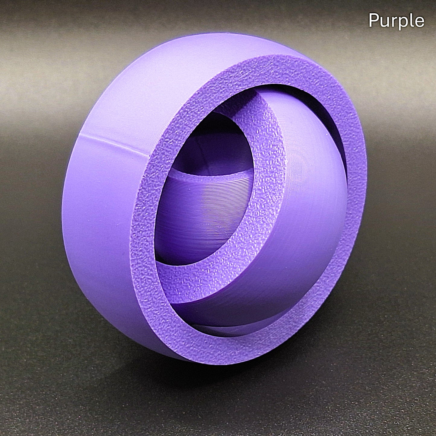 Purple smooth gyro spinner with a sleek, seamless exterior, made from biodegradable PLA for anxiety relief and quiet sensory play.
