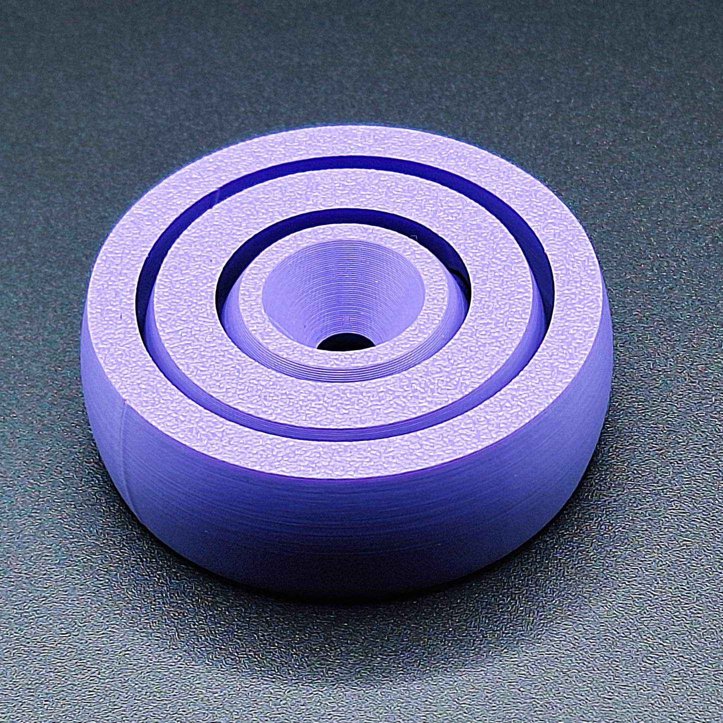 Top view of smooth-edge fidget spinner toy, designed for calming focus, handmade in the USA using sustainable, plant-based plastic.