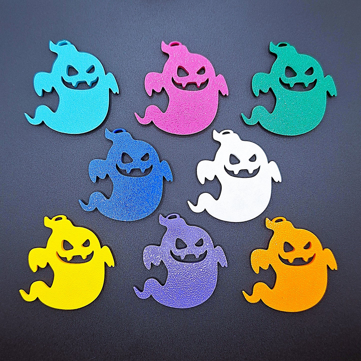 Side-by-side view of eight spooky ghost keychains in bold colors, ideal for fidgeting, gifting, or accessorizing Halloween-themed bags or keys.