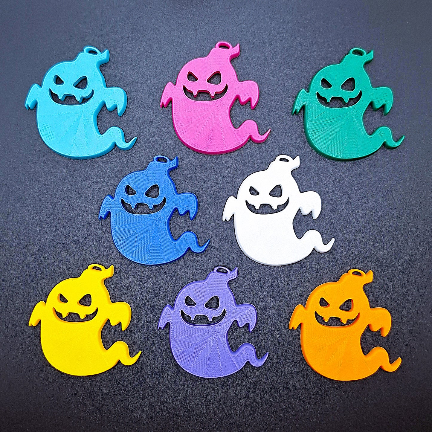 Reverse side of eight ghost keychains showing smooth PLA surface, perfect for spooky key rings, party bags, or small Halloween surprises.
