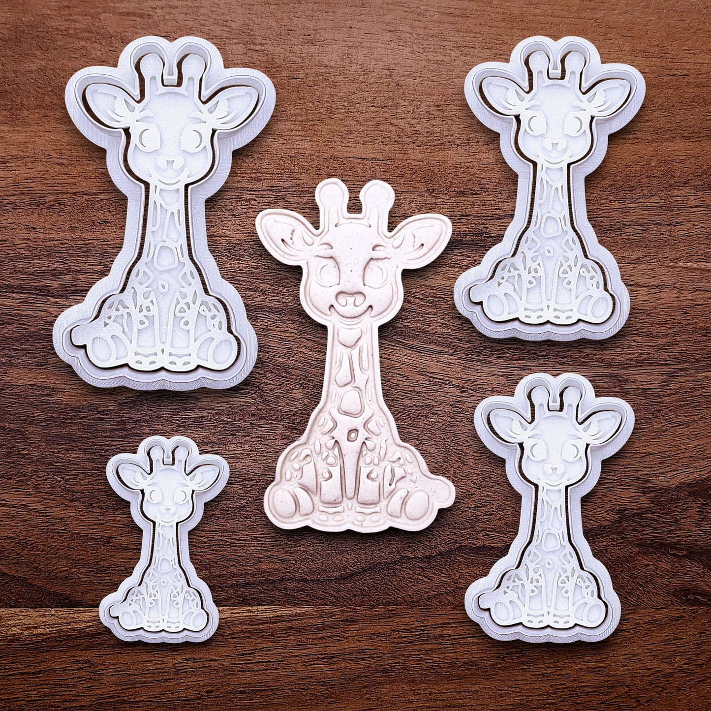 Multiple giraffe cookie cutters with matching stamps. Creates cute safari cookies or fondant toppers with charming animal detail.
