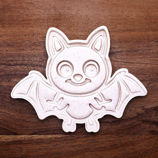 Close-up of bat cookie cutter dough imprint, perfect for spooky Halloween cookies, fondant crafts, and gothic-themed baking projects.