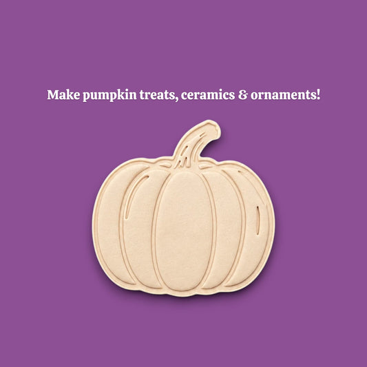 Pumpkin cookie dough cutout with stamped details from the cutter and stamp set; demonstrates textured lines and stem impression.