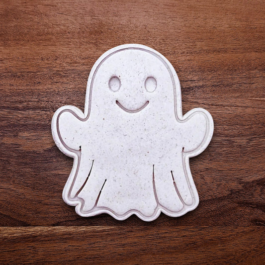 Ghost cookie cutter stamping spooky face into dough – great for Halloween cookies, fondant, or crafts with clean, detailed imprints.