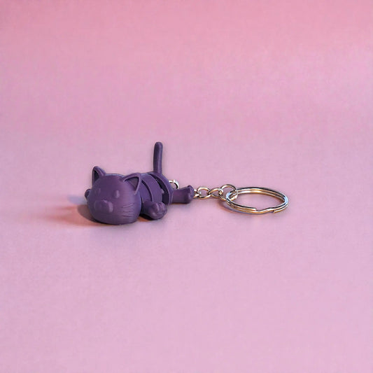 Handmade and customizable articulated cat keychain in indigo purple, great for keys, backpacks, and small gifts with charm.