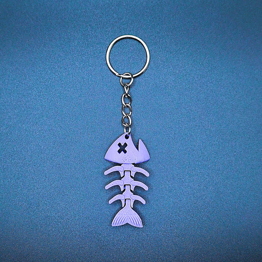 Purple articulated fish keychain featuring connected segments for movement, handmade from PLA plastic for fun fidget or aquatic gifting.