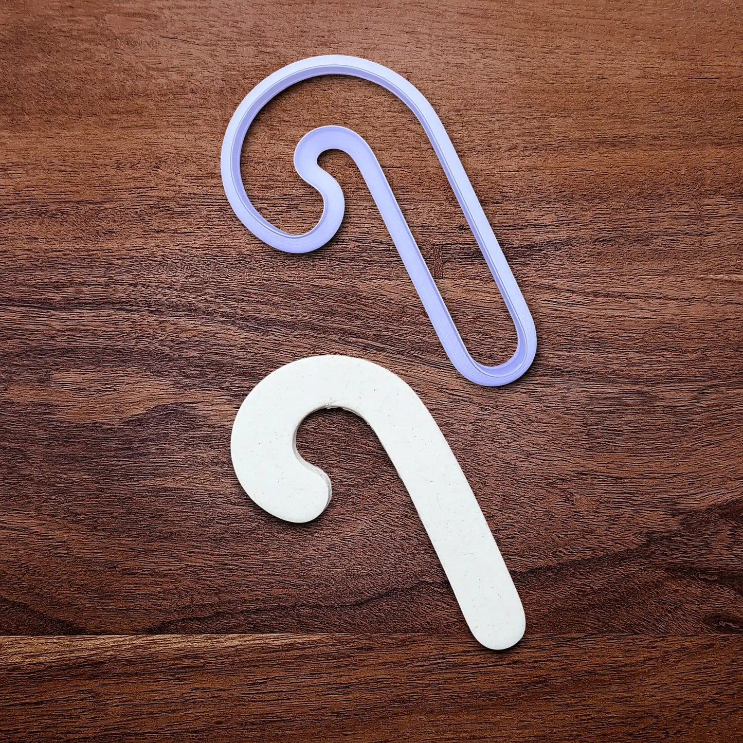 Handmade and customizable Christmas holiday Candy Cane Cookie Cutter alongside a dough cutout - perfect for Christmas cookies, festive gifts, and fun seasonal family baking activities.