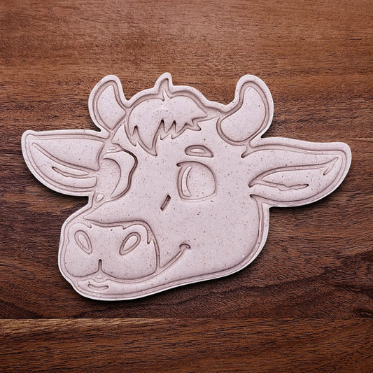 Handmade and customizable cow cookie cutter dough cutout and imprint, perfect for farm-themed baking and kids’ country birthday party treats.