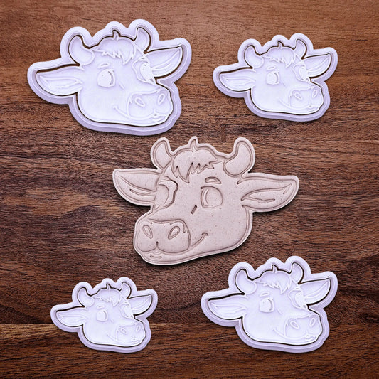 Handmade and customizable cow cookie cutters and stamps alongside a cow dough cutout and imprint, perfect for farm-themed baking and kids’ country birthday party treats.