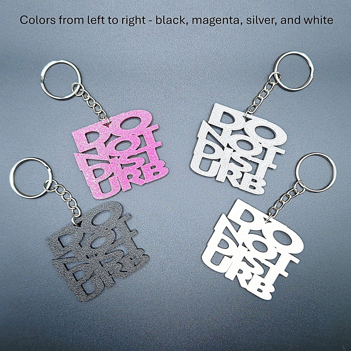 Four Do Not Disturb keychains shown in different colors, bold text design, perfect for privacy, work-from-home setups, or gamer accessories.