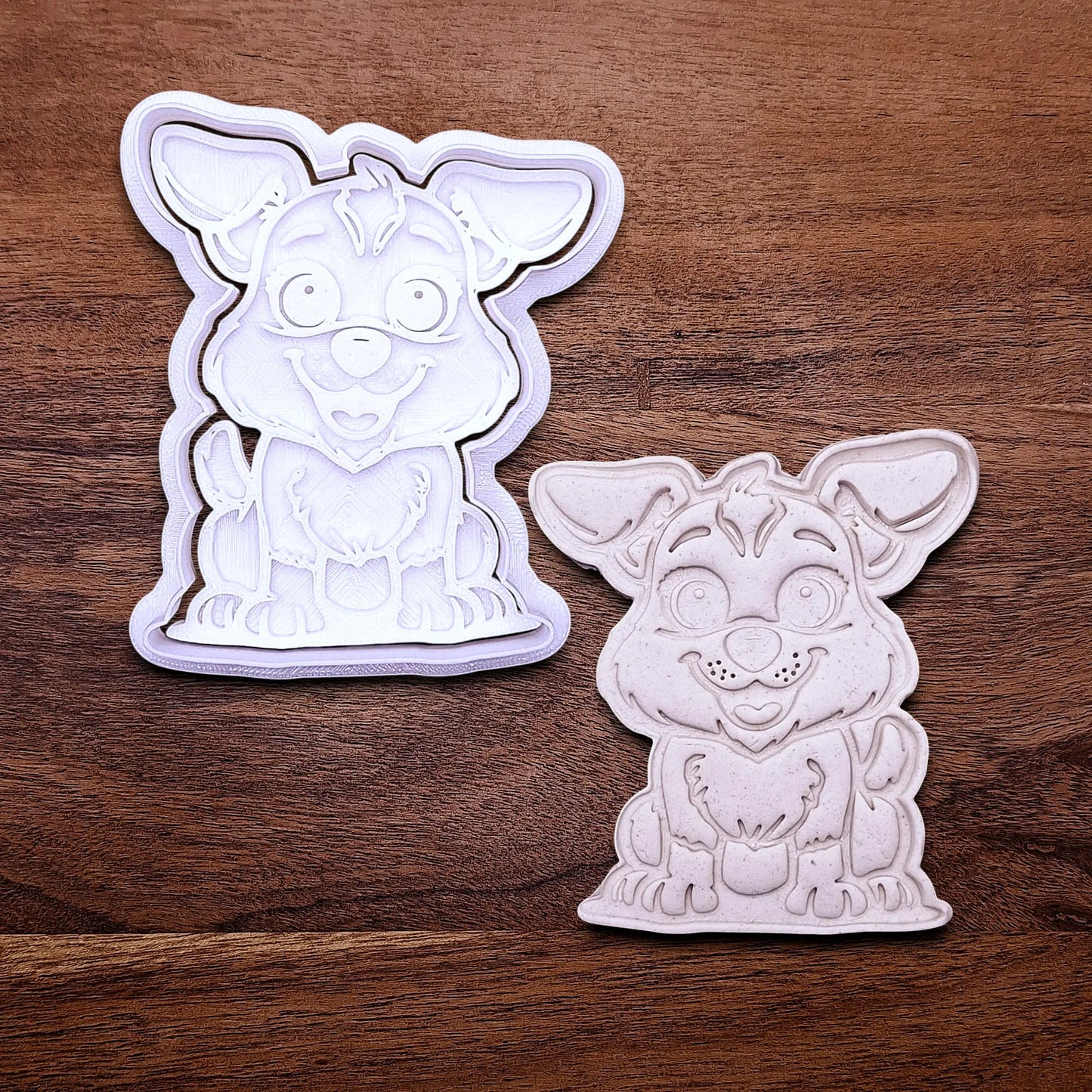 Handmade and customizable dog cookie cutter with stamp alongside a dough cutout and imprint, perfect for cookies, fondant, crafts and pet treats.