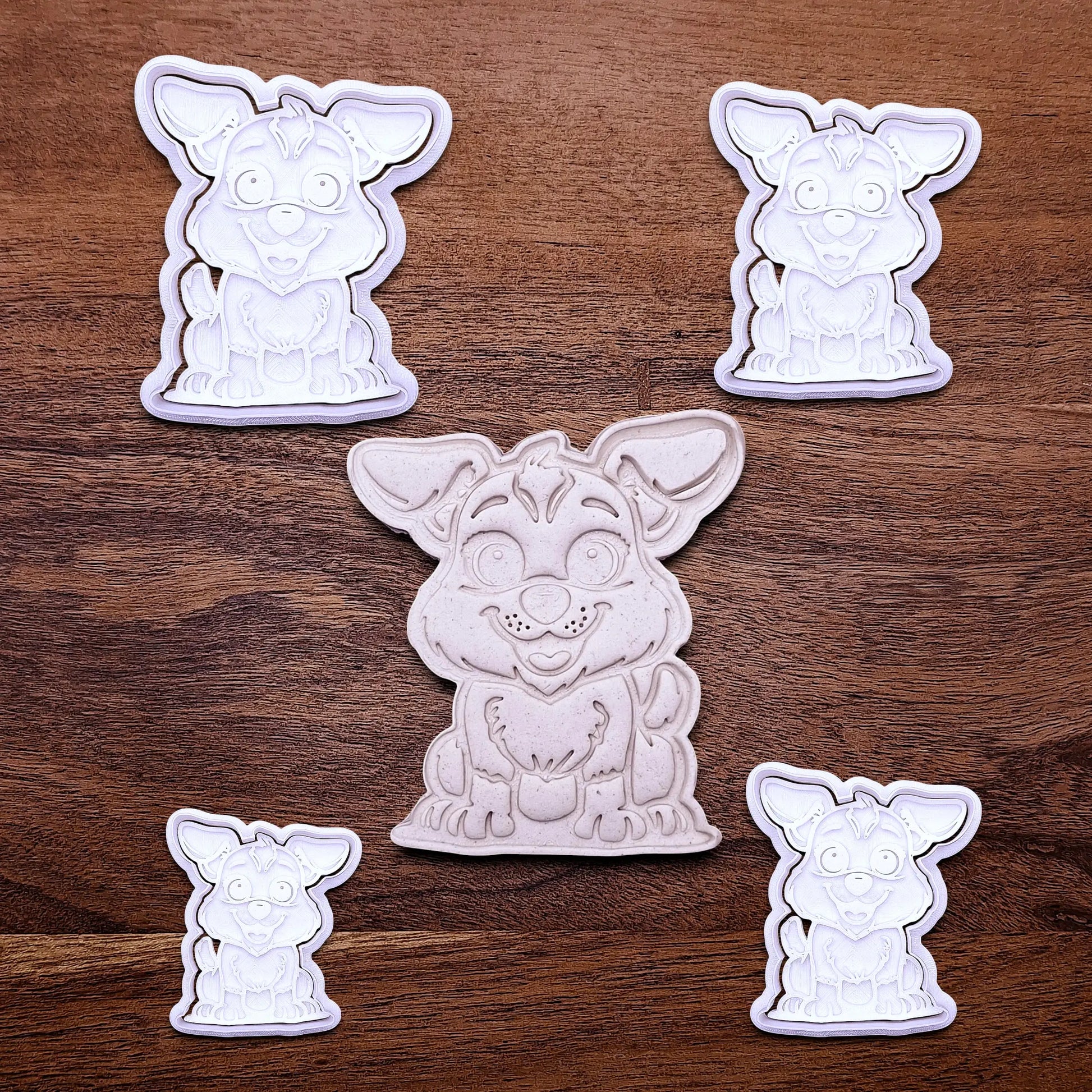 Handmade and customizable dog cookie cutters with stamps alongside a dough cutout and imprint, perfect for cookies, fondant, crafts and pet treats.