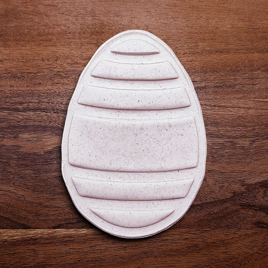 Handmade and customizable Easter egg shaped cookie cutout and imprint, perfect for Easter celebrations, spring parties, and birthday treats.