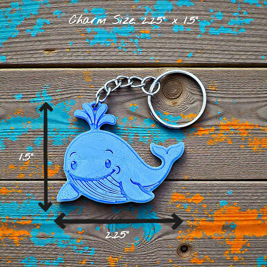 Handmade and customizable whale keychain in blue featuring a friendly aquatic design, perfect for classroom prizes, party favors for kids birthdays, and unique bag charms.