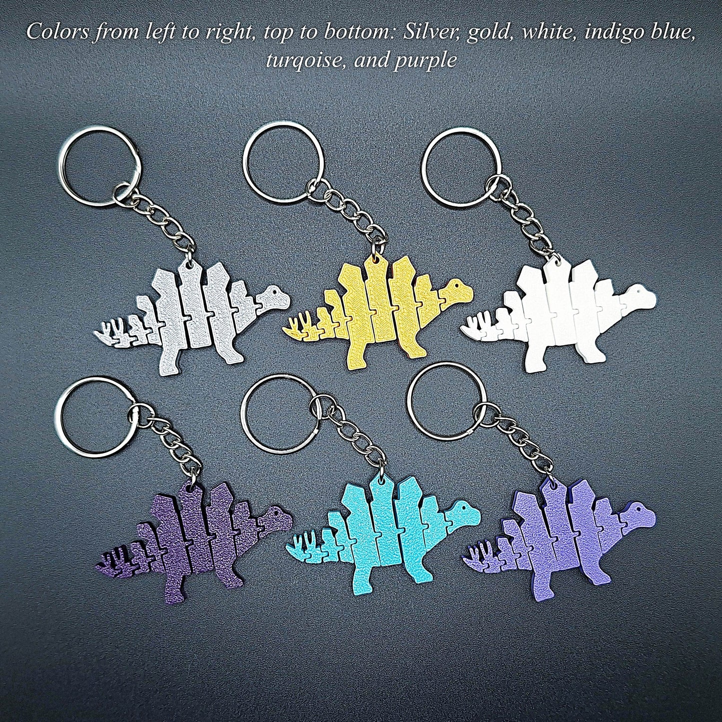 Six dinosaur fidget keychains shown in assorted colors, featuring articulated design perfect for kids, sensory play, and handmade dino gifts.