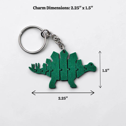 Handmade and customizable dinosaur fidget keychain in white, featuring colorful articulated designs, perfect for kids birthday parties, classroom prizes, sensory play, and party favor dino gifts.