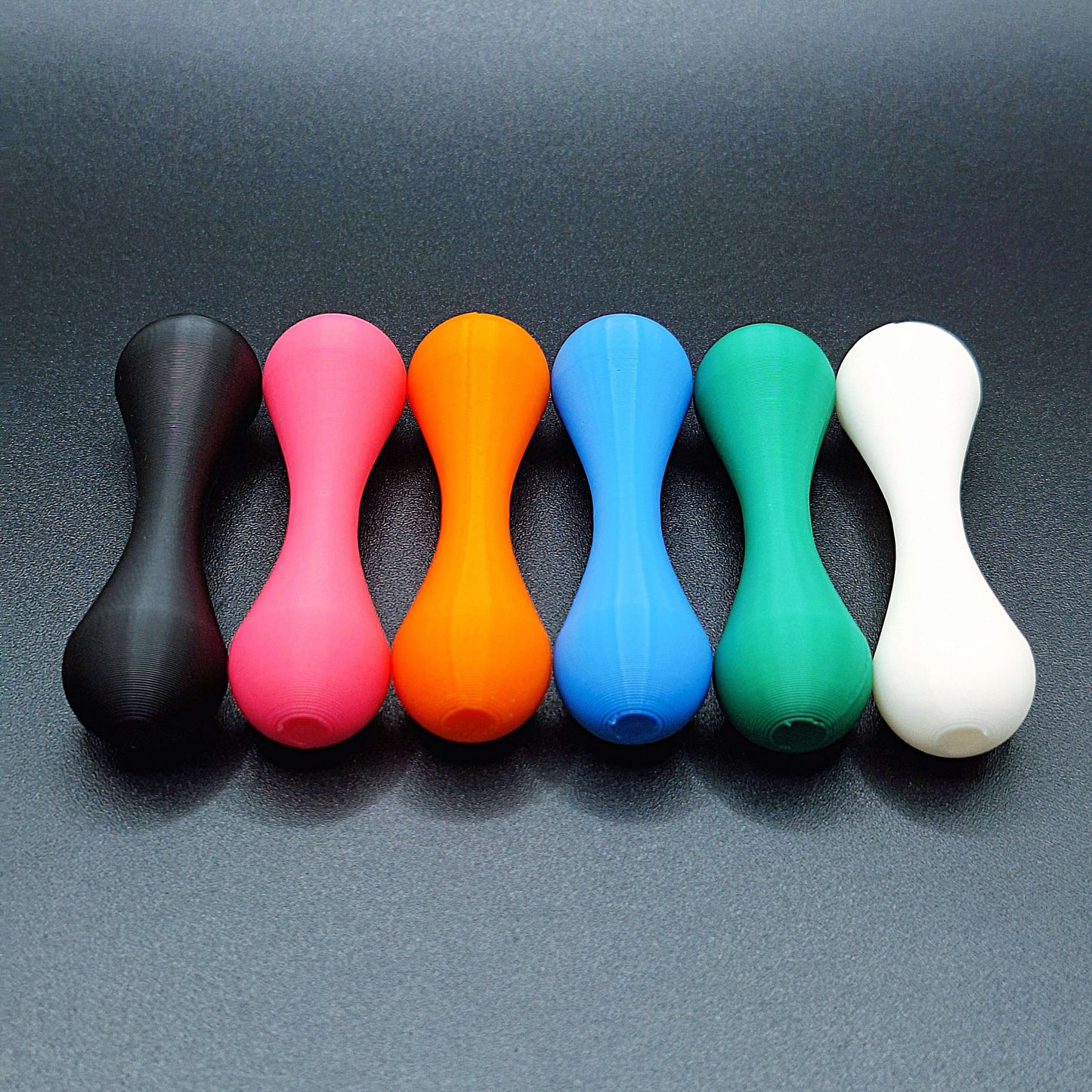 Top-down view of six knucklebone fidget skill toys made from eco-friendly PLA, great for focus, flipping tricks, and mindful fidgeting.