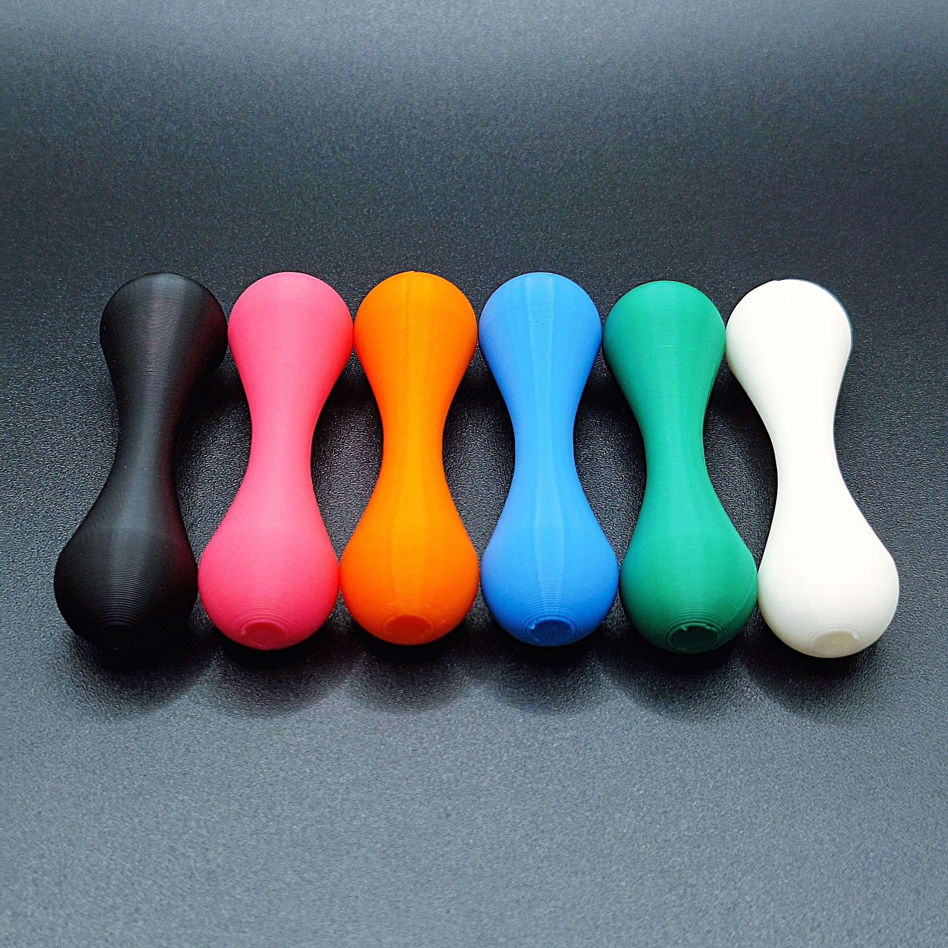 Top-down view of six knucklebone fidget skill toys made from eco-friendly PLA, great for focus, flipping tricks, and mindful fidgeting.