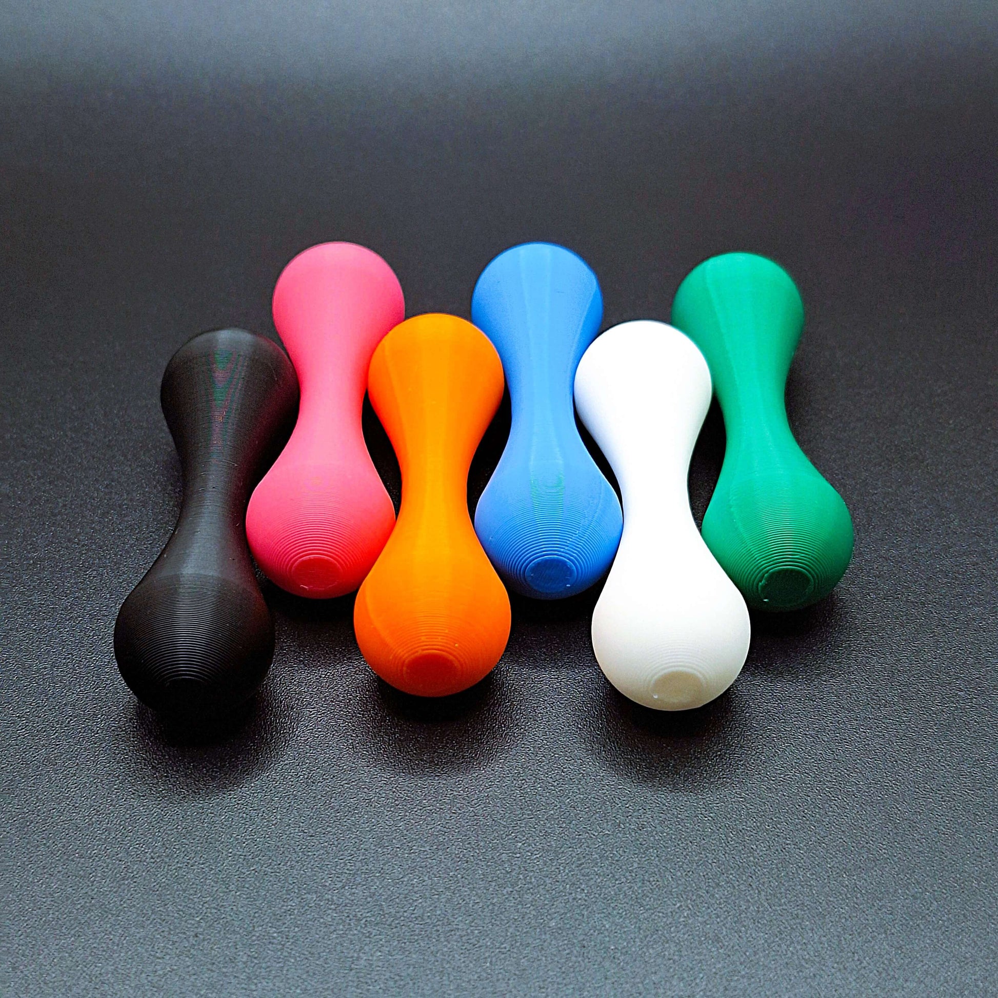 Assorted knucklebone fidget toys in multiple colors, perfect for flipping, rolling, and improving hand coordination and stress relief.