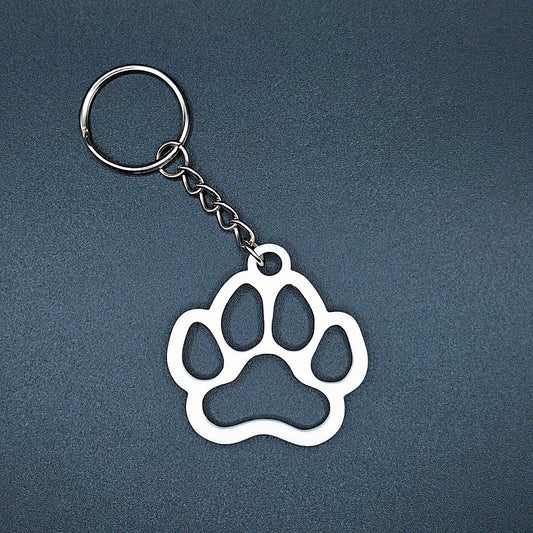 White paw keychain with clean silhouette, eco-friendly and handmade, ideal for honoring pets, gifting to animal lovers, or everyday use.