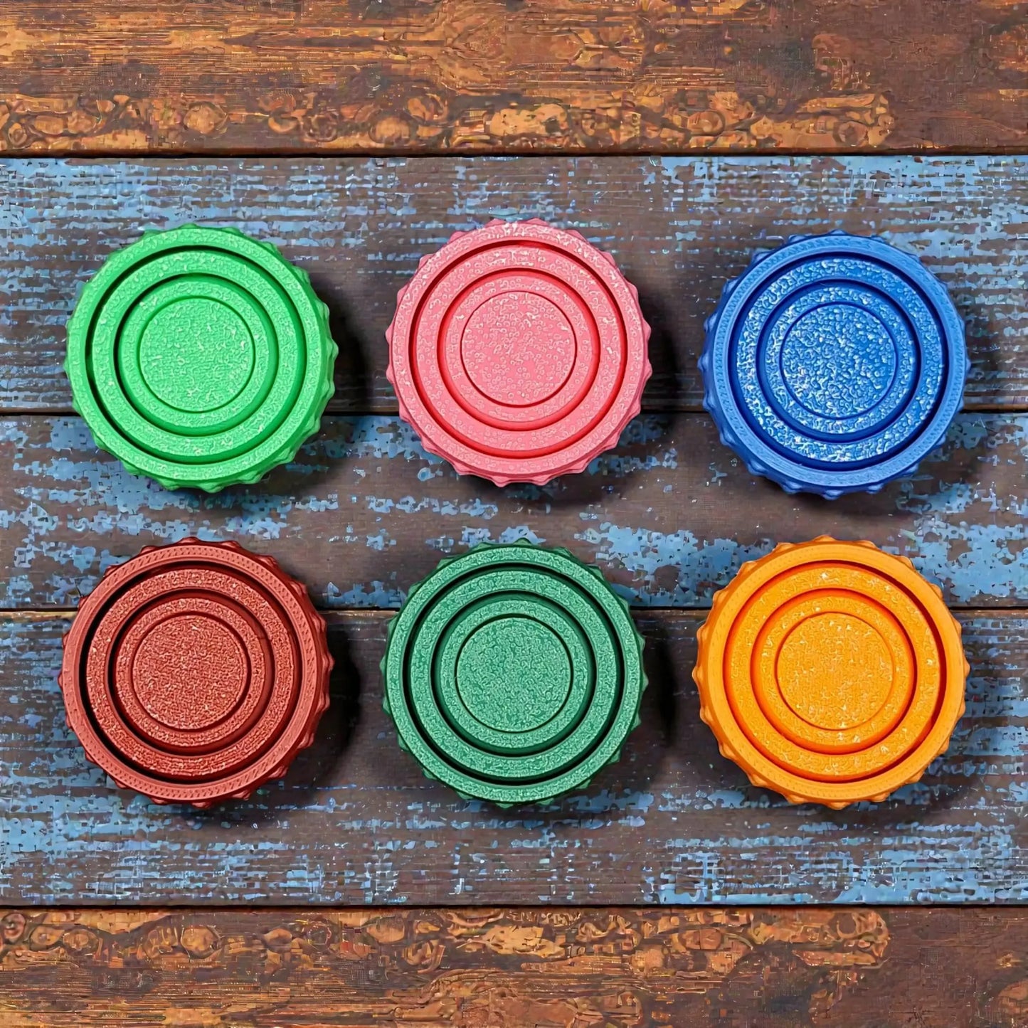 Top view of six colorful pocket fidget spinners, great for anxiety, sensory needs, and focus on the go—compact and eco-conscious design.