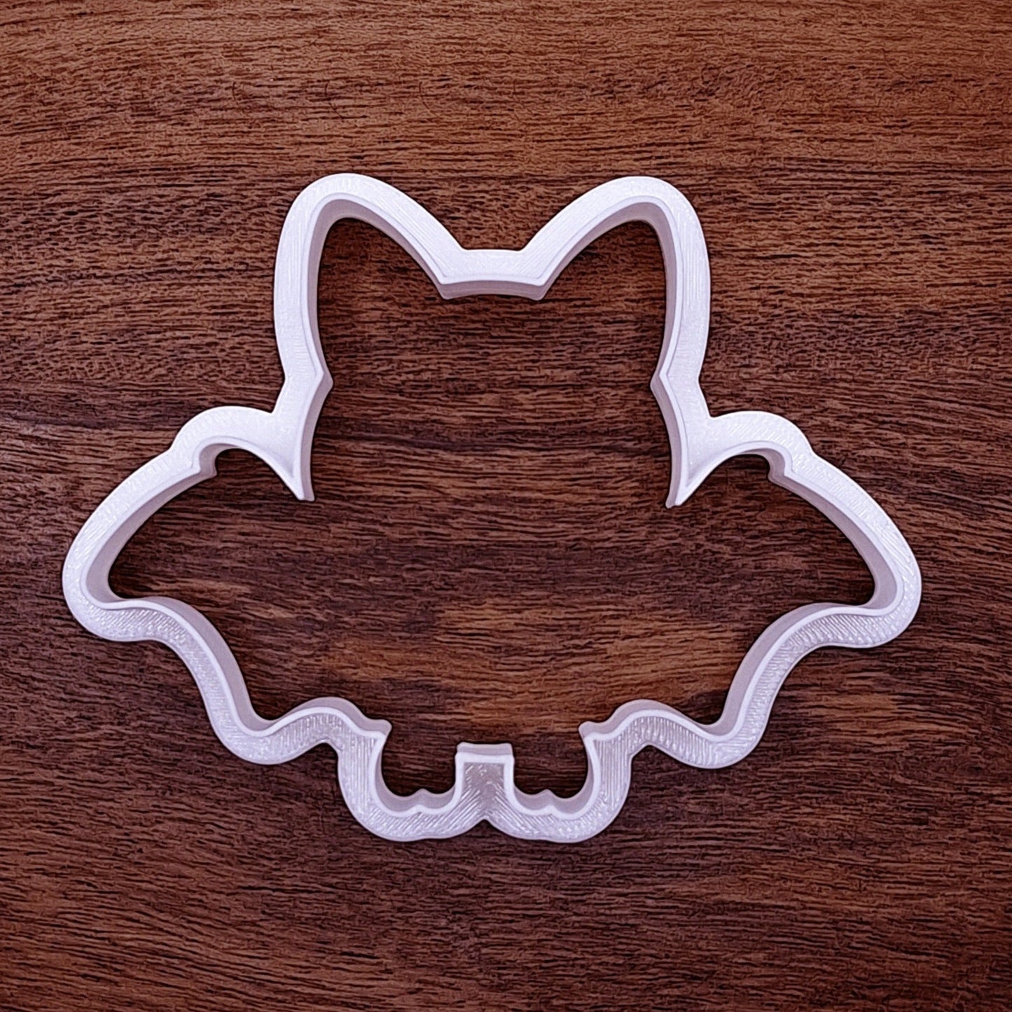 Simple bat-shaped cookie cutter in black plastic, great for Halloween baking, haunted house parties, and bat-themed cookie trays or crafts.