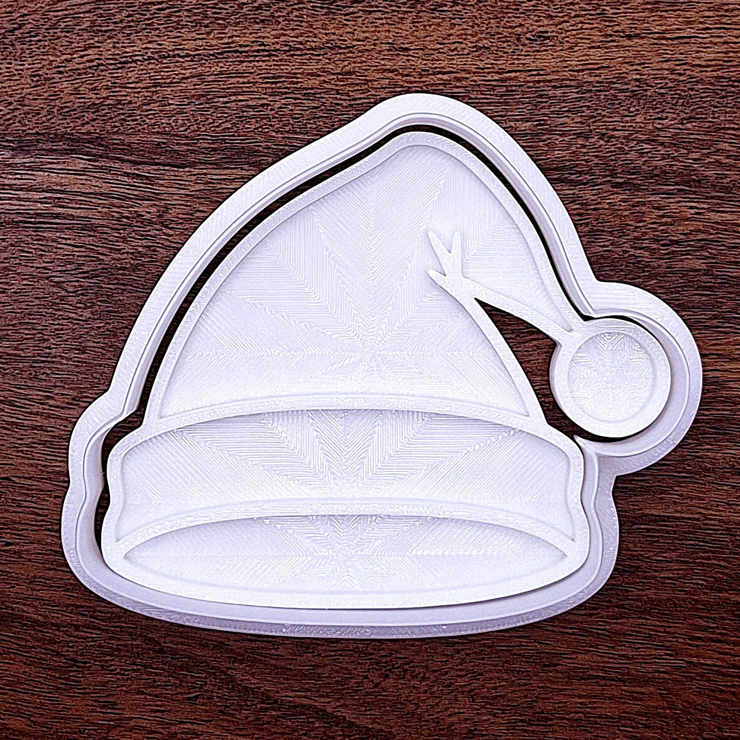 Santa hat cookie cutter with fluffy brim stamp detail. Great for party platters or fondant cupcake toppers.