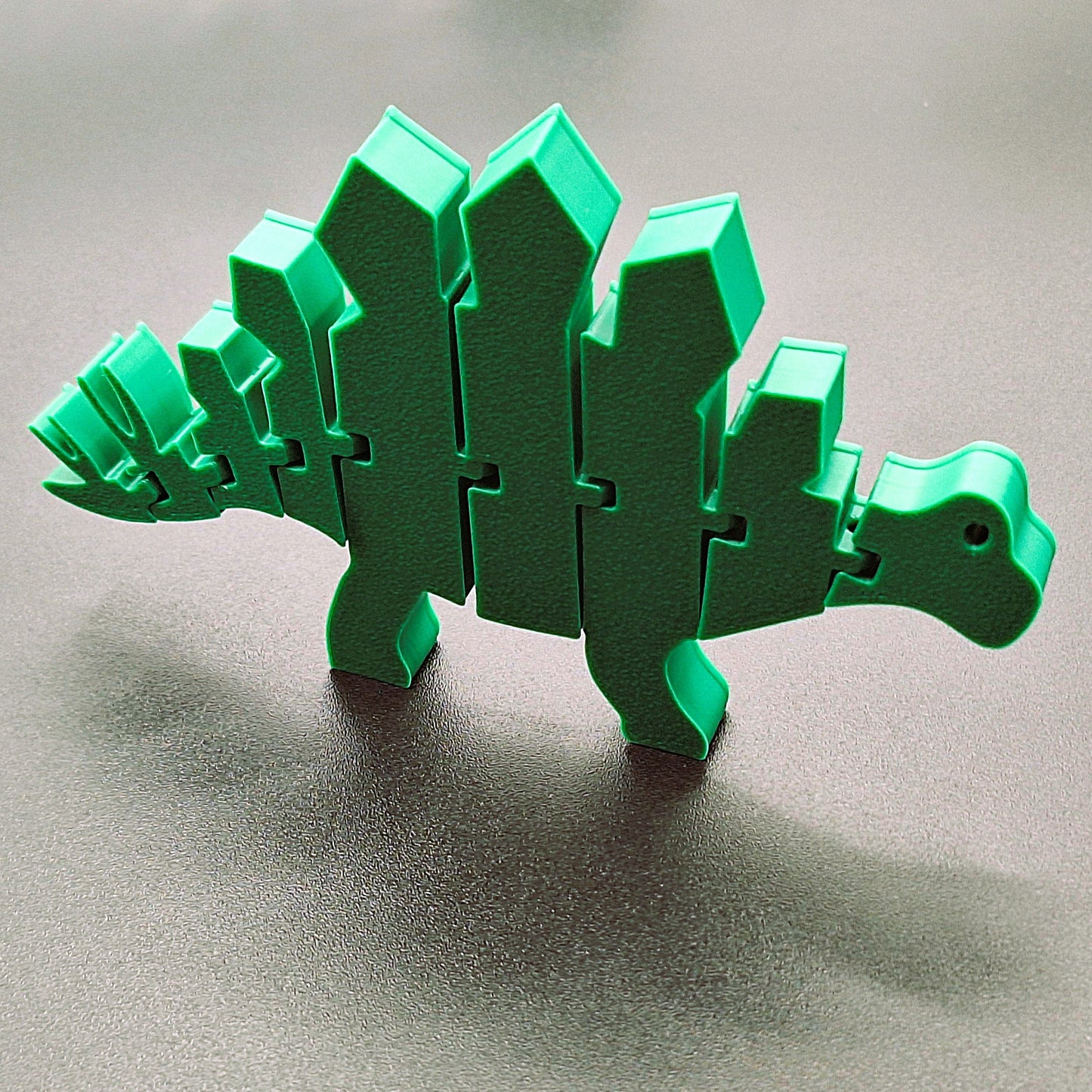 Poseable stegosaurus fidget dinosaur that stands and bends, ideal for kids, collectors, classroom rewards, and desk stress relief.