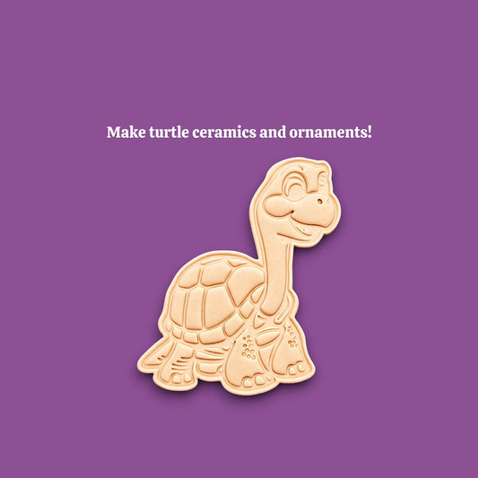 A turtle-shaped cookie and ceramic mold shown on a solid purple background, with the text 'Make turtle ceramics and ornaments!' above it.