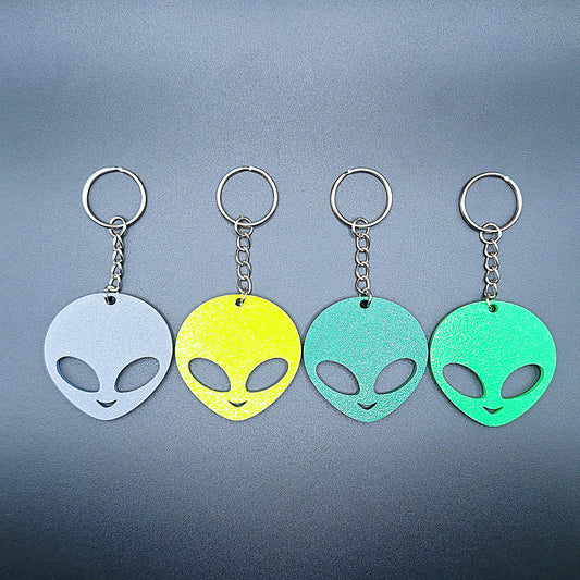 Alien head keychains in four different colors displayed side by side, perfect for sci-fi fans, party favors, or fun personalized gifts.