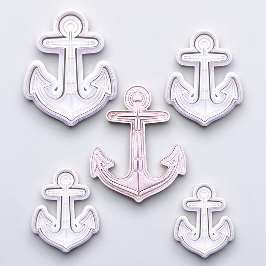 View of multiple anchor cookie cutters with matching stamps. Ideal for making detailed cookies, fondant toppers, or ocean party treats.