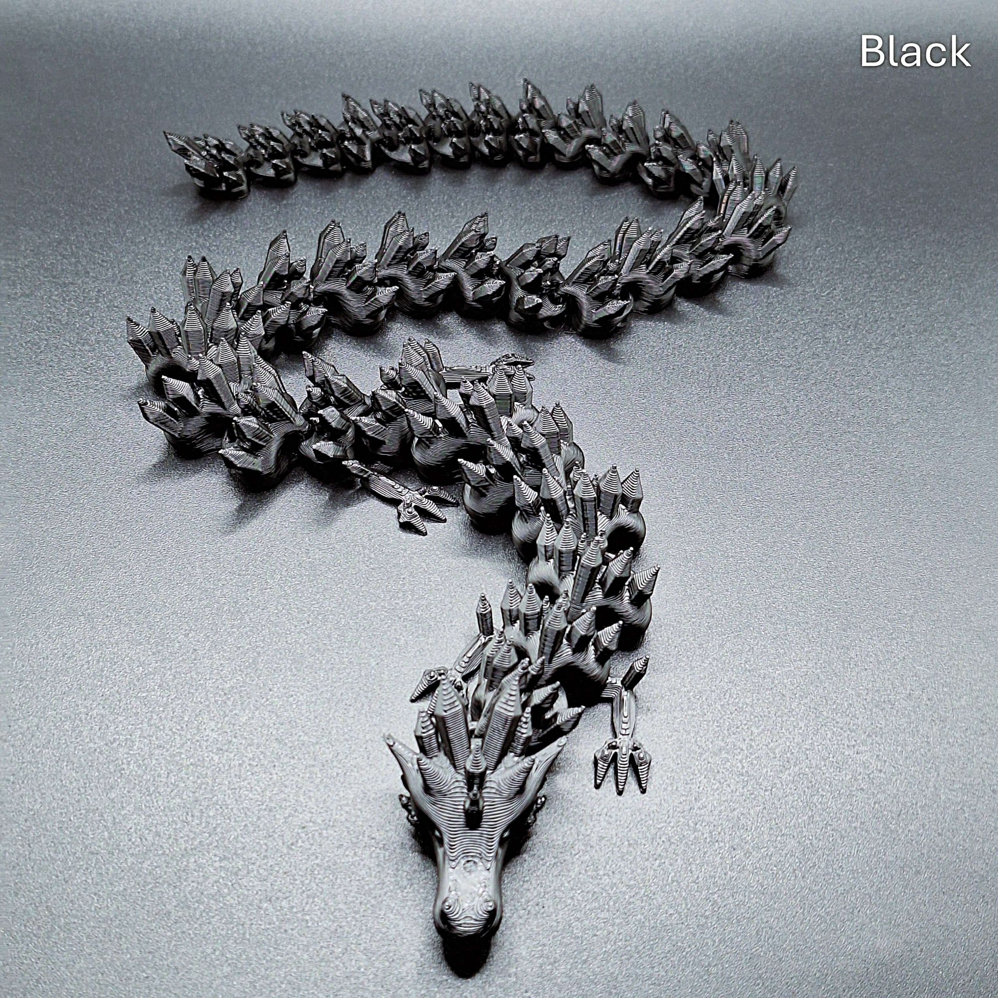 Black articulated dragon toy with smooth, movable segments, 3D printed in eco PLA plastic, ideal for stress relief and collectors.