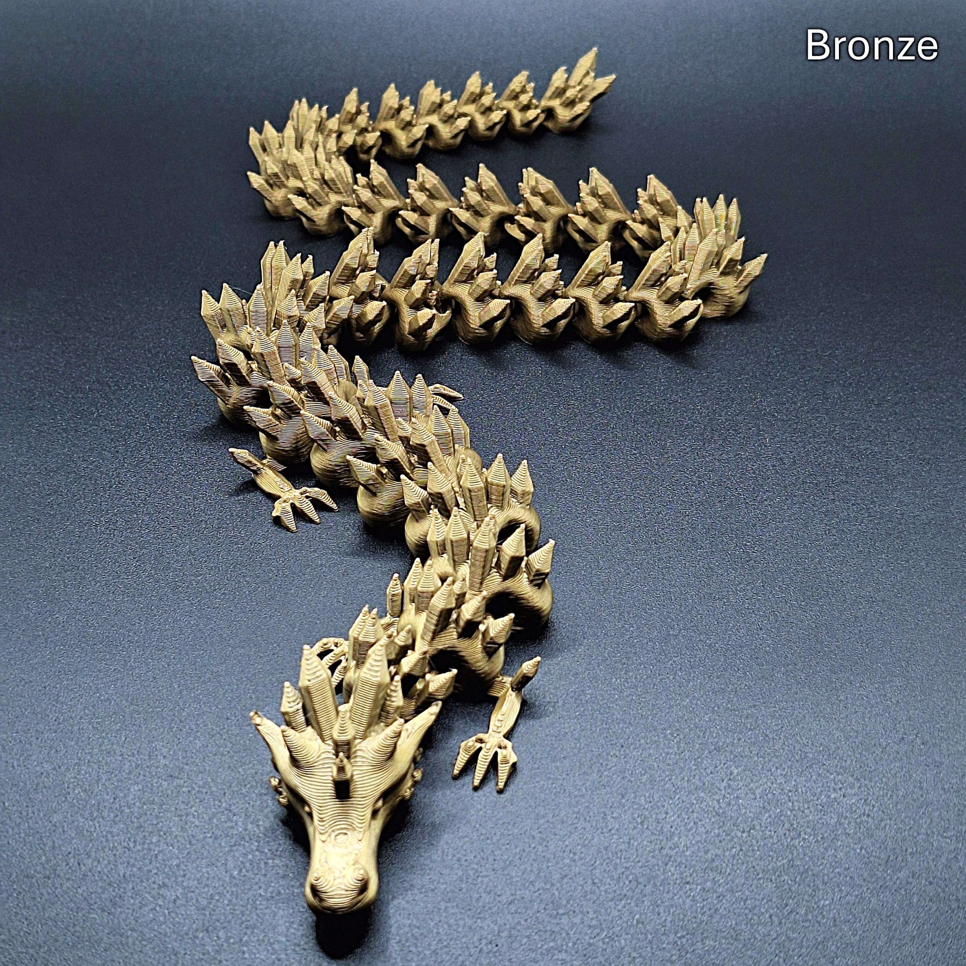 Bronze articulated dragon fidget toy in metallic finish, features poseable limbs and tail, eco-friendly PLA plastic, great fantasy gift.