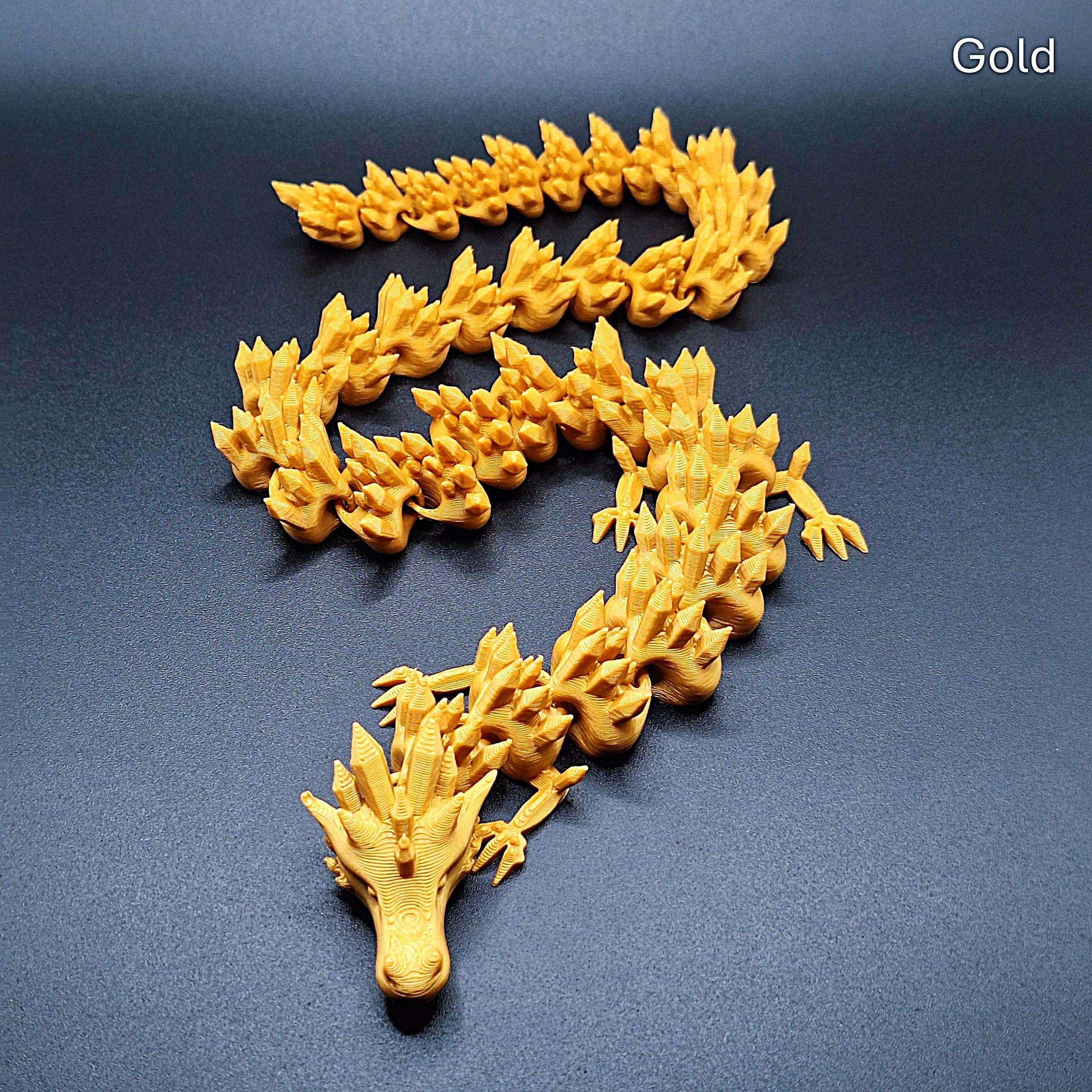 Gold dragon fidget toy with full articulation, handmade from compostable PLA, detailed and perfect for fantasy lovers or display.