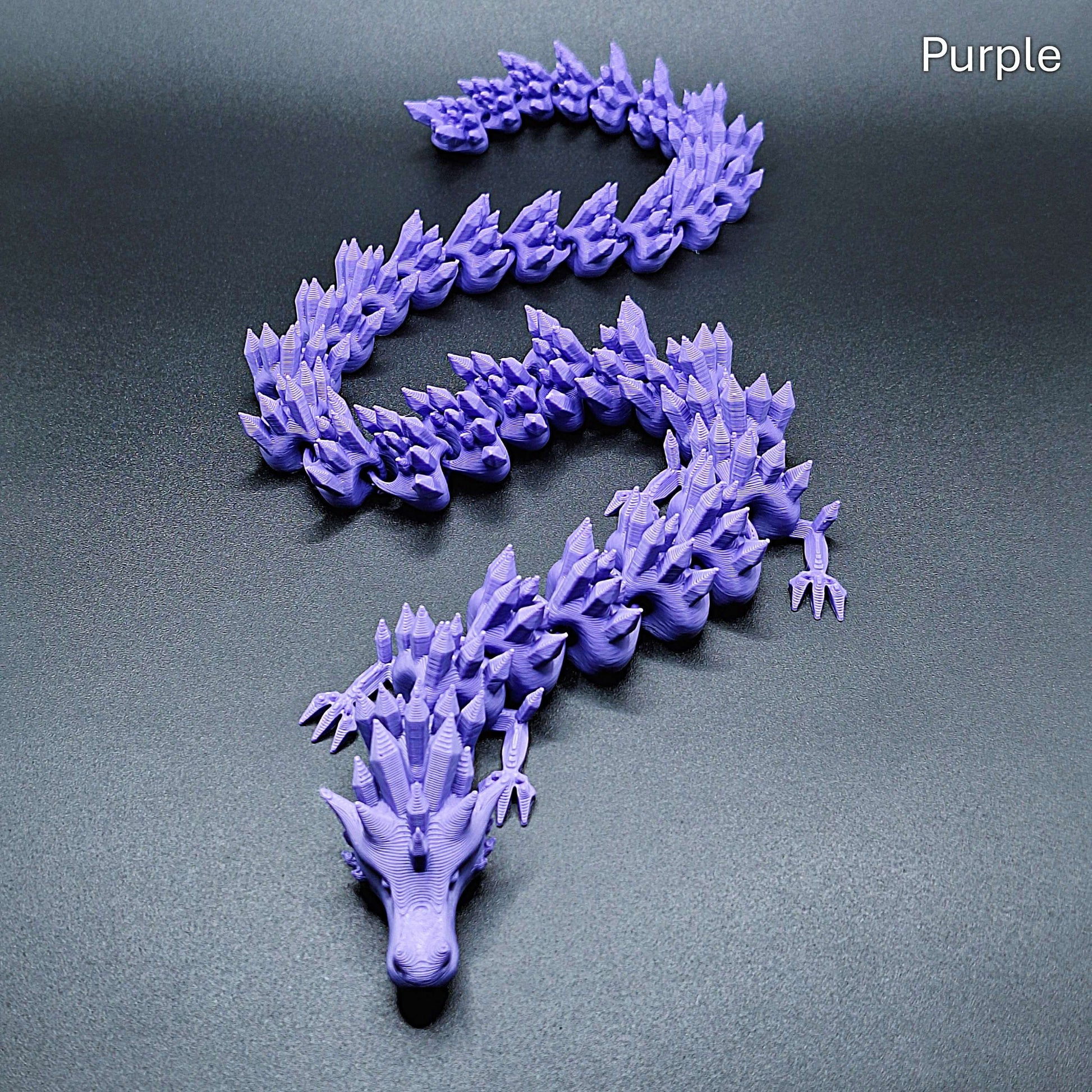 Purple articulated dragon with poseable segments, eco PLA design, ideal for fidgeting, decor, or gifting to dragon and fantasy fans.