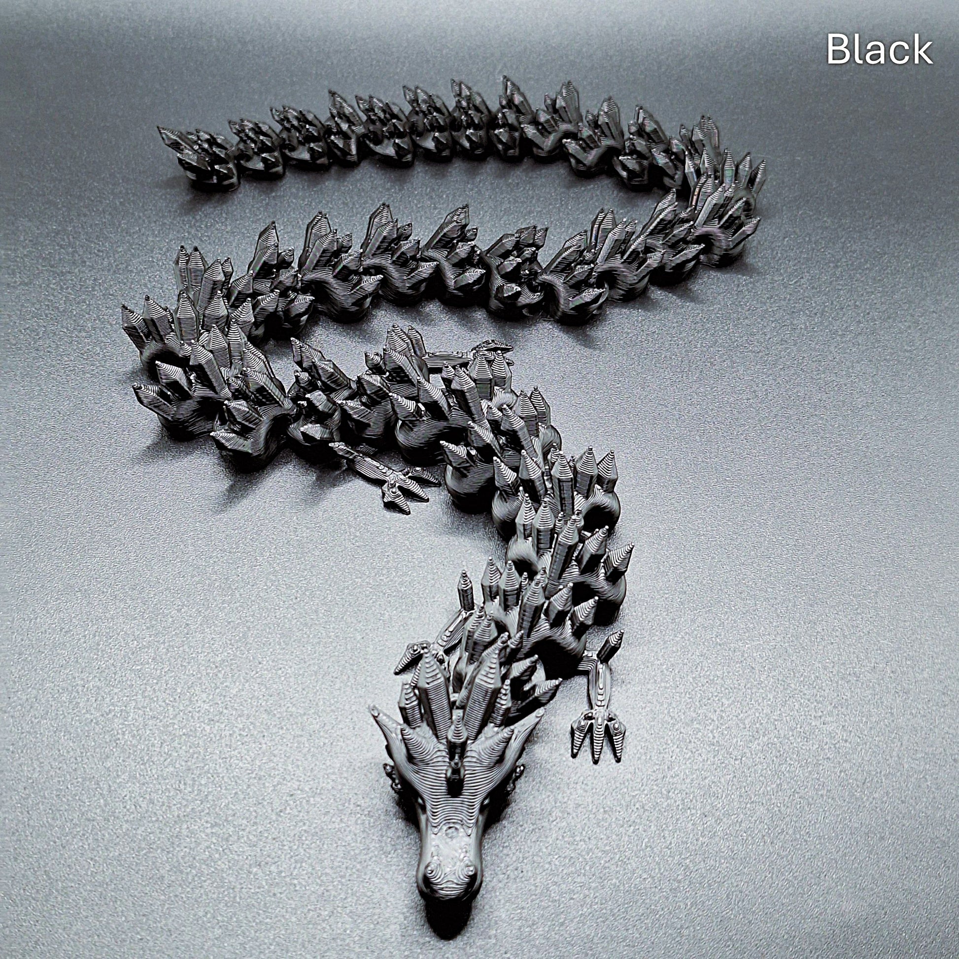 Magenta articulated dragon toy with smooth, movable segments, 3D printed in eco PLA plastic, ideal for stress relief and collectors.