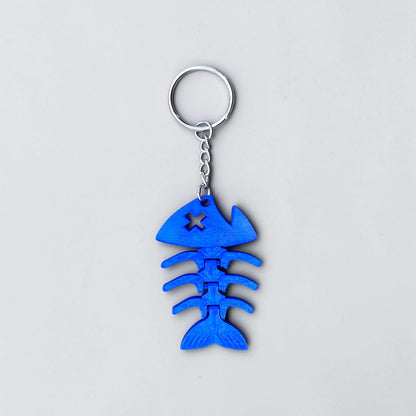Articulated and jointed fish keychain shown in blue, perfect for gag gifts, stocking stuffers and party favors.